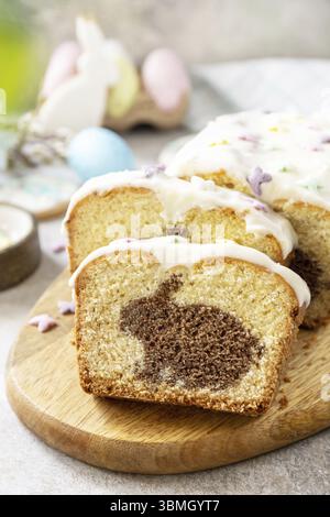 Happy Easter holiday food baking, cupcake with Easter Bunny and colorful eggs on stone background Stock Photo