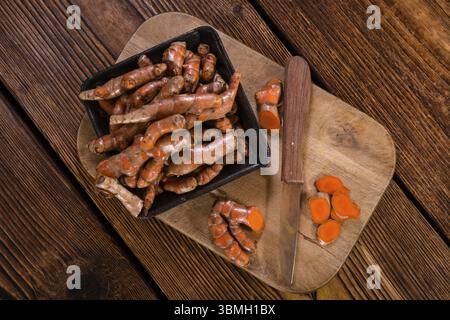 An old wooden table with Turmeric (selective focus, close-up shot) Stock Photo