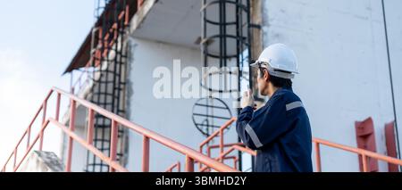 maintenance and inspector. Maintenance engineers are using walky talky to inform the results of inspection of buildings and structures. Irrigation eng Stock Photo