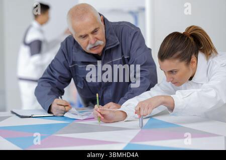 female apprentice decorator in training Stock Photo