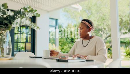 Black woman, coffee and mug with drink on outdoor table for morning caffeine or beverage at home. Female person, freelancer or remote worker with cup Stock Photo