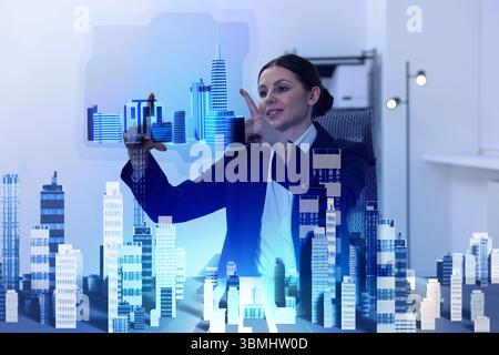 Building information modelling. Woman using holographic projection of city in office Stock Photo