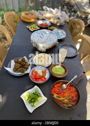 Traditional Arabic breakfast table, tomato skillet, hummus, beans, and falafel. Stock Photo