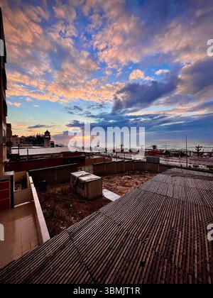 Beautiful winter clouds over the sea beach during sunset. Stock Photo