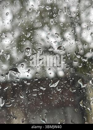 Water drops on a window during winter cold background. Stock Photo