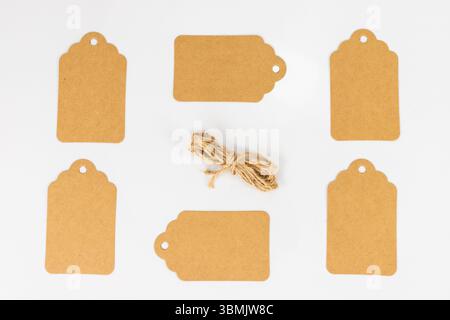 A Set of Brown Tags with Jute String on White Isolated Background Stock Photo