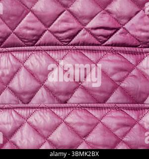 Seamless 4k photo texture of purple colored stitched and patterned bologna cloth material. Stock Photo