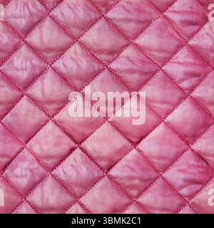 Seamless 4k photo texture of purple colored quilted, stitched and patterned bologna cloth material. Stock Photo