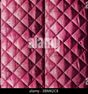 Seamless 4k photo texture of purple colored quilted, stitched and patterned bologna cloth material. Stock Photo