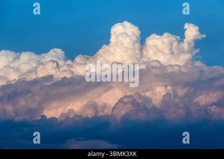Closeup abstract image of big fluffy clouds in the sky with blue hues and texture Stock Photo