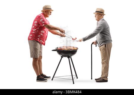 Mature man giving a grilled bbq sausage to another man isolated on white background Stock Photo