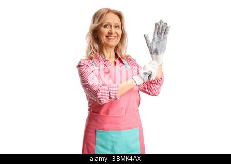 Woman wearing apron and putting on gloves isolated on white background Stock Photo