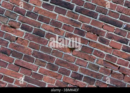 Diagonal view of a red brick wall. Textured architectural background Stock Photo