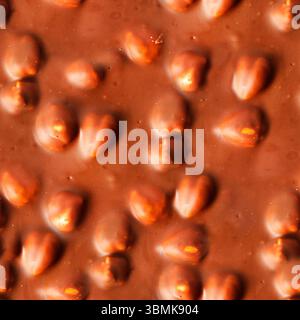 Seamless 4k photo texture of milk chocolate with hazelnuts surface. Stock Photo