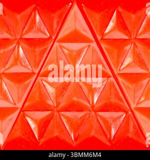 Seamless 4k photo texture material of red colored geometric patterned ornate plastic surface. Stock Photo
