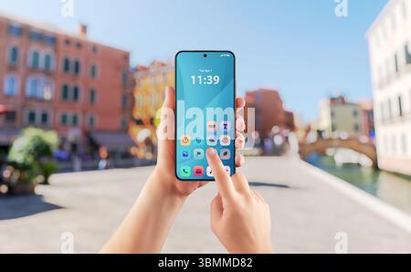 Smartphone app interface used outdoors on sunny day, perfect for travel, lifestyle or navigation apps Stock Photo