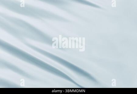 Detail of soft white fabric waving in the wind, perfect for backgrounds, textures, or minimalistic visual concepts and digital designs Stock Photo