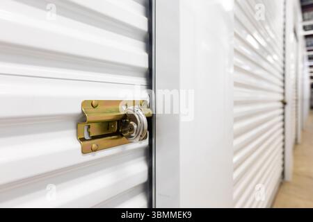 Key lock securing door on self storage unit. Stock Photo