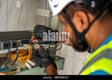 Technician and engineer team fixing network devices, routers, configuring servers, and repairing cables in network room. IT maintenance Stock Photo