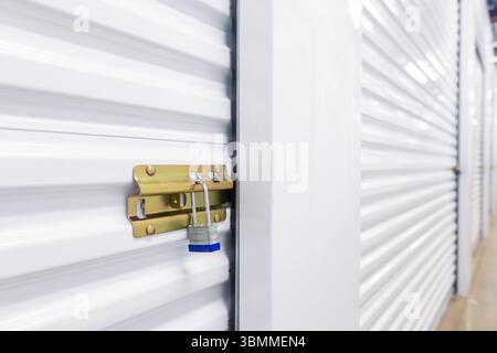 Key lock securing door on self storage unit. Stock Photo