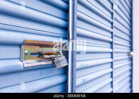 Key lock securing door on self storage unit. Stock Photo