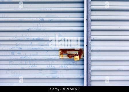 Key lock securing door on self storage unit. Stock Photo