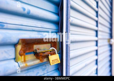 Key lock securing door on self storage unit. Stock Photo