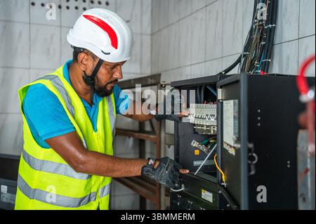 Technician and engineer team fixing network devices, routers, configuring servers, and repairing cables in network room. IT maintenance Stock Photo