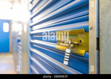 Combination lock securing door on self storage unit. Stock Photo