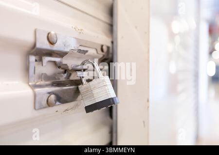 Key lock securing door on self storage unit. Stock Photo