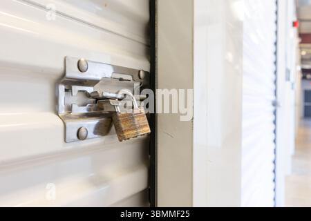 Key lock securing door on self storage unit. Stock Photo