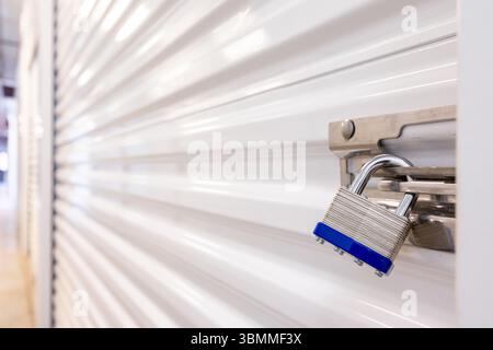 Key lock securing door on self storage unit. Stock Photo
