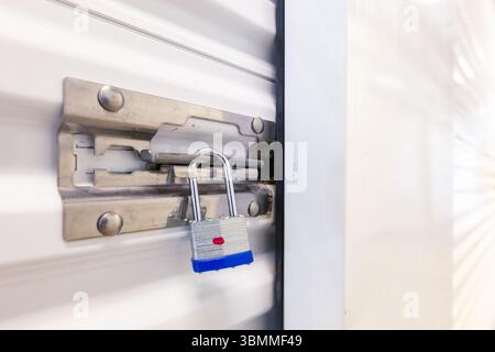 Key lock securing door on self storage unit. Stock Photo