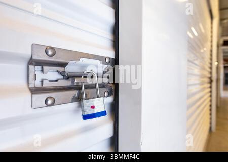 Key lock securing door on self storage unit. Stock Photo