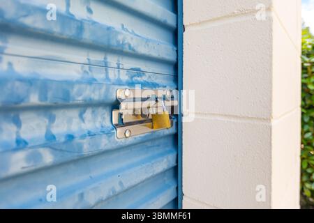Key lock securing door on self storage unit. Stock Photo