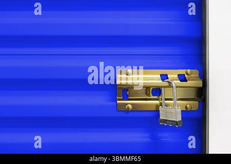 Key lock securing door on self storage unit. Stock Photo