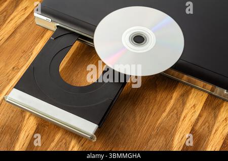 Photo of cd or dvd player with compact disc laying on it. Stock Photo
