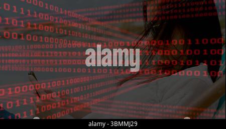 Woman wearing white shirt holding smartphone in dim room, with red binary code overlay, copy space Stock Photo