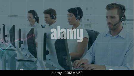 Working group of four call center agents typing and speaking at office workstations, with headsets Stock Photo