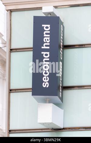 A second-hand store sign with the words "second hand" and "second chance" on the facade of a modern building, Austria, Vienna, June 27, 2025. Stock Photo