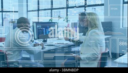Collaborating three professionals analyzing data charts in office meeting area, with dual monitors Stock Photo