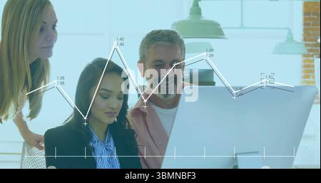 Analyzing data by three professionals on large desktop monitor in office, with pendant lights Stock Photo