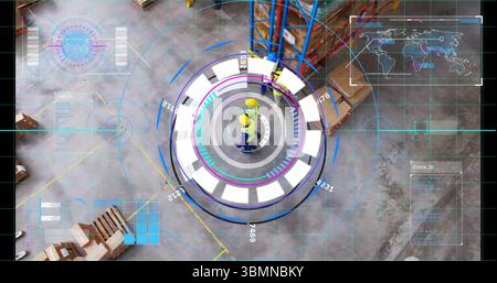 Monitoring two workers wearing yellow hard hats using holographic interface at warehouse with racks Stock Photo