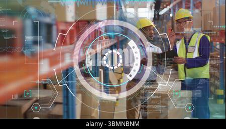 Checking inventory two workers in yellow hard hats using tablet on warehouse racks, copy space Stock Photo