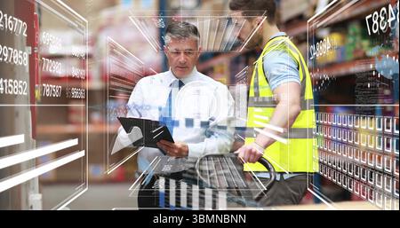 Reviewing digital overlay, tie-clad manager and vested worker using pallet jack in warehouse aisle Stock Photo