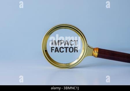 IMPACT FACTOR text written on sticky with pencil and glasses Stock Photo