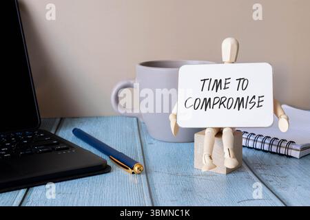 time to compromise text on cubes on wooden background. Stock Photo
