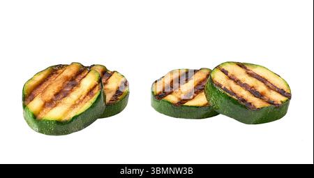 Grilled zucchini slices isolated on white background. Healthy summer veggie food. Fried zucchini slices. Stock Photo