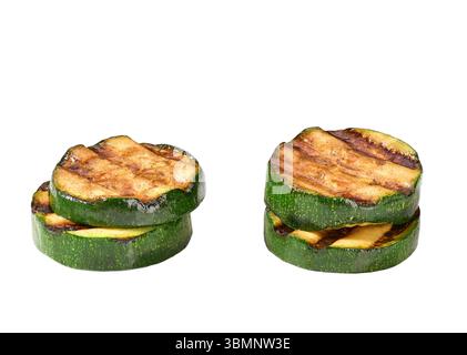 Grilled zucchini slices isolated on white background. Healthy summer veggie food. Fried zucchini slices. Stock Photo