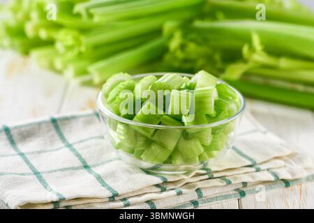 Sliced fresh celery or celery stalk on cutting wooden board. celery stalk Stock Photo